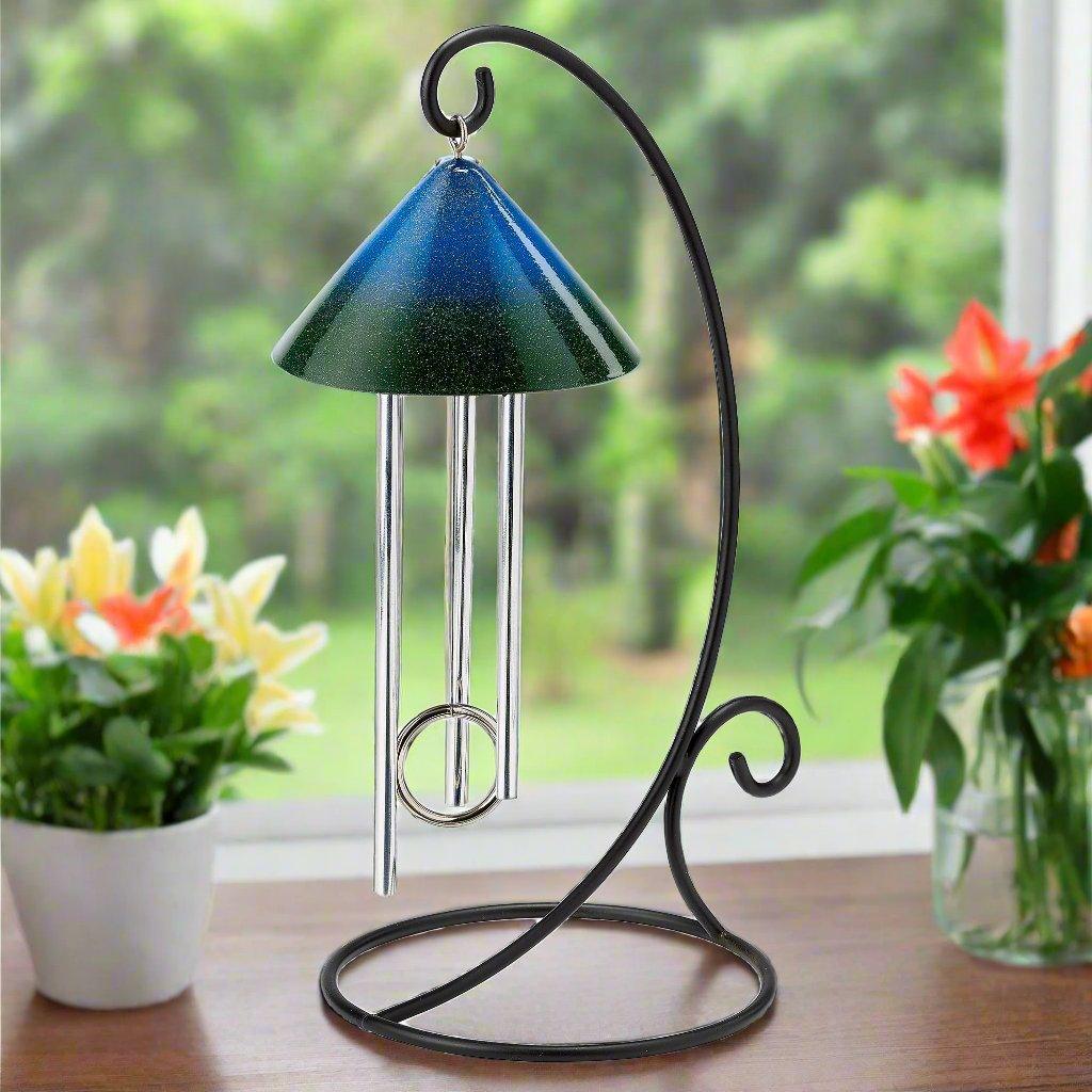 Solar indoor wind chime with forest green and blue sky colors makes for a cheerful window sill decoration