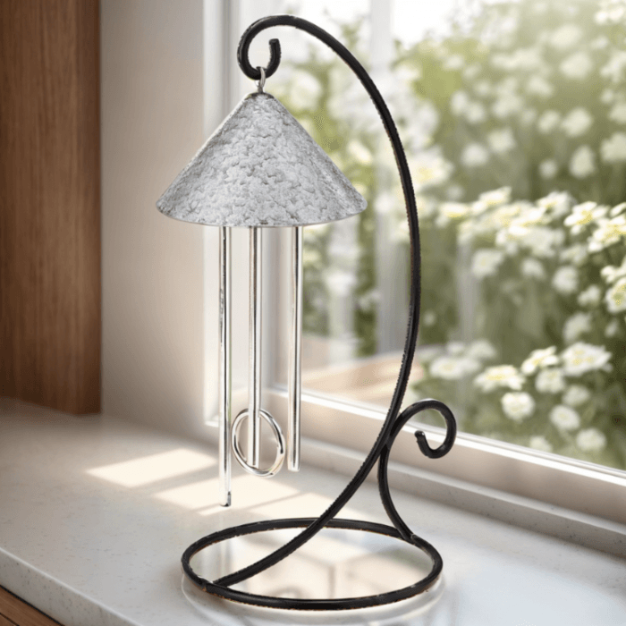 pewter solar wind chime on sunny window ledge