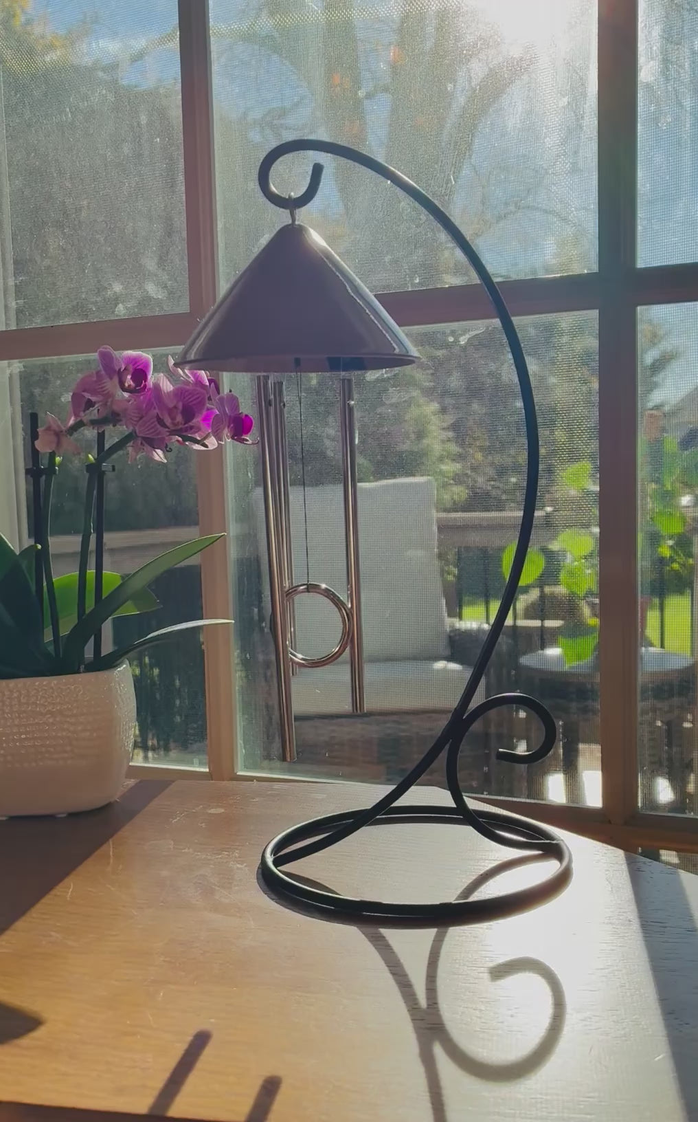 Video of the Sprite indoor solar wind chime gently chiming in sunlight